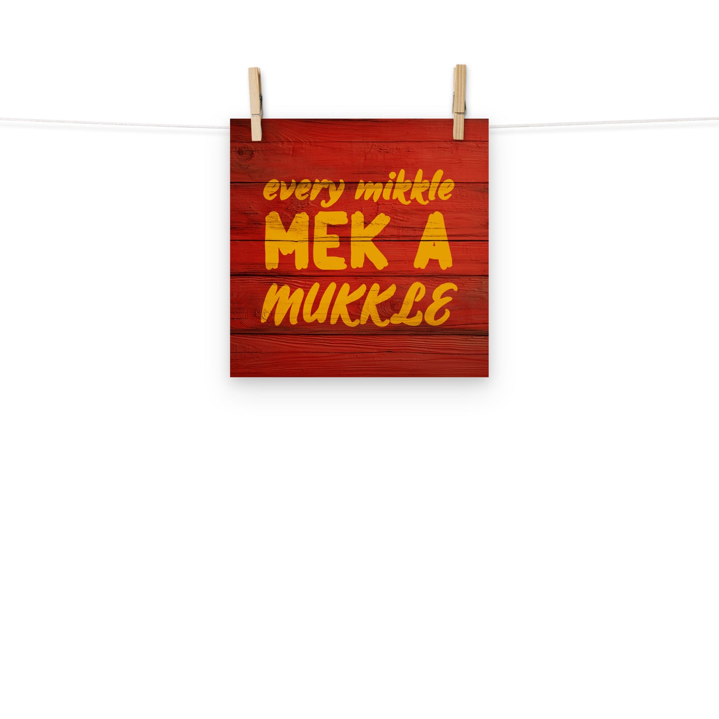 Digital wall art of the words "every mikkle mek a mukkle" painted on wood, a common Jamaican colloquialism meaning every little bit adds to up something bigger.