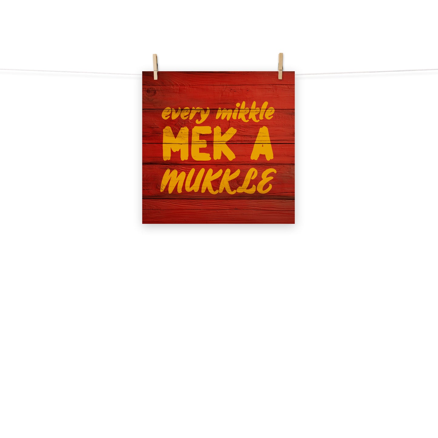 Digital wall art of the words "every mikkle mek a mukkle" painted on wood, a common Jamaican colloquialism meaning every little bit adds to up something bigger.