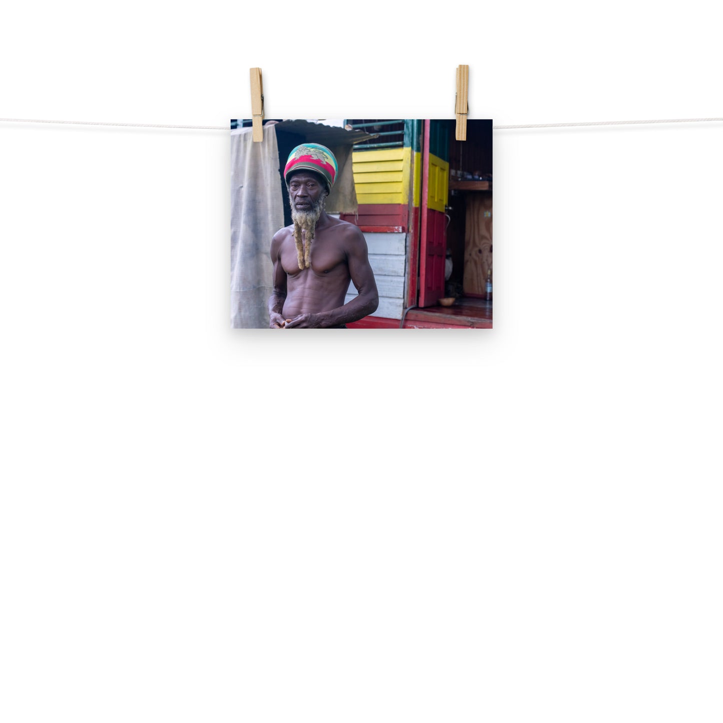 A vibrant photo of a Rastaman handing before his house in the hills of Hanover, Jamaica.