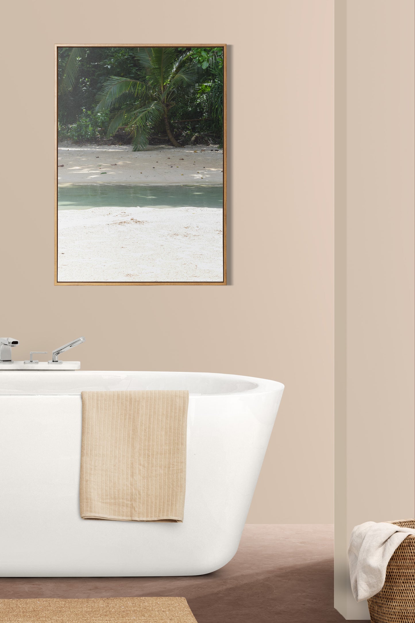 A photo of where the river meets the sea at Frenchman's Cove in Portland, Jamaica framed on the wall of a luxurious bathroom.