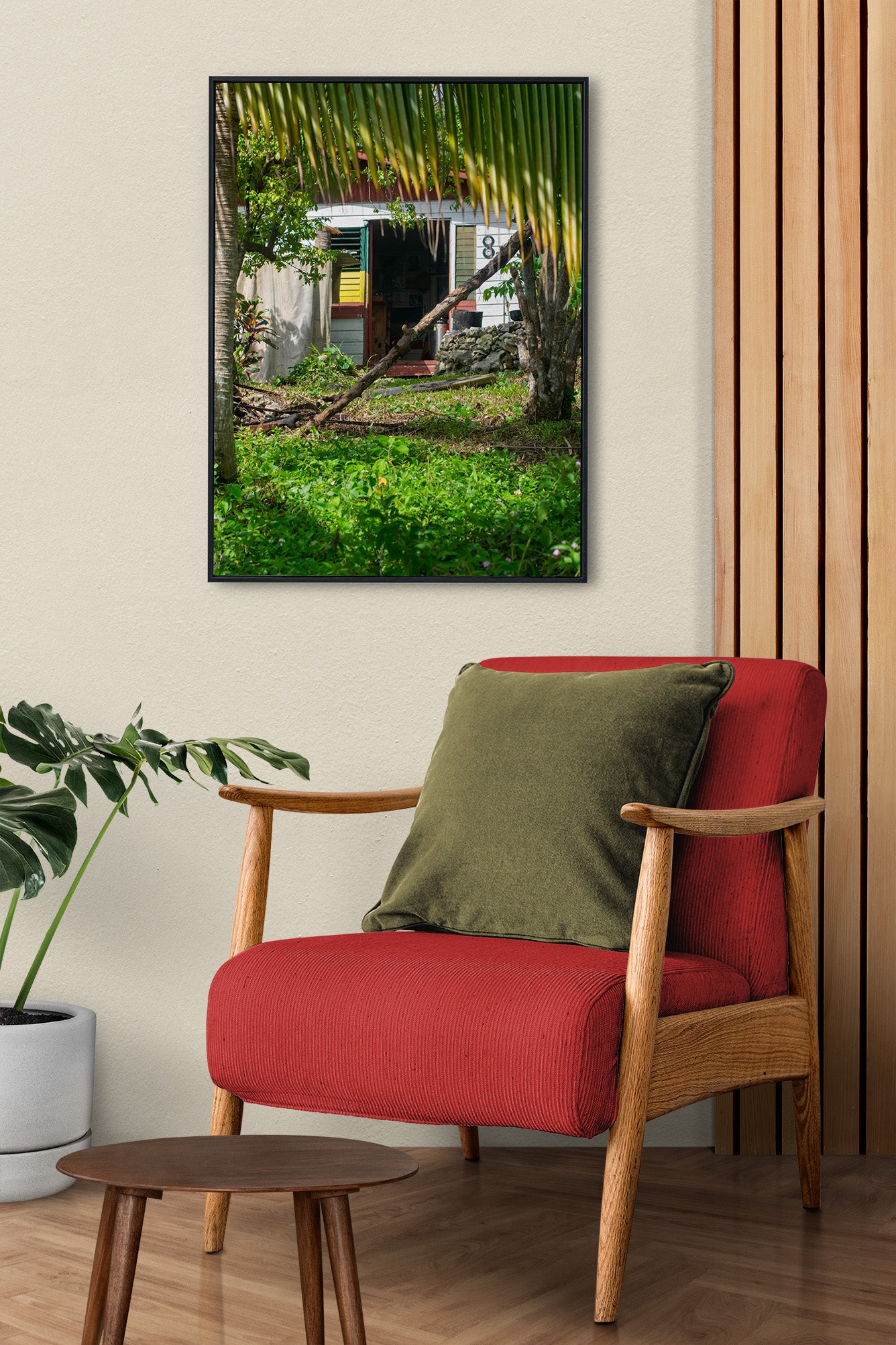 A vibrant photo of a Rastaman's house in the hills of rural Hanover, Jamaica above an accent chair.