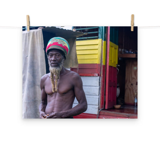 A vibrant photo of a Rastaman handing before his house in the hills of Hanover, Jamaica.